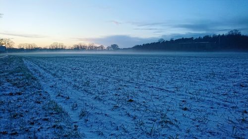 Scenic view of frozen lake against sky during winter