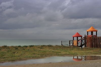 Lifeguard hut on beach against sky