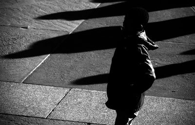 Shadow of woman standing on wall