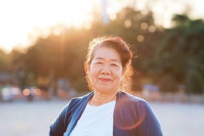 Portrait of smiling senior woman standing outdoors