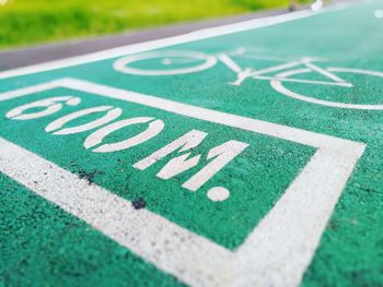 Bicycle lane sign and numbers on footpath