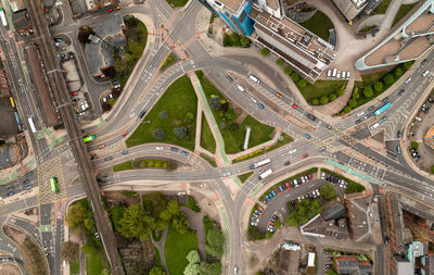 Aerial view directly above complex road junction or intersection with traffic moving  in a big city