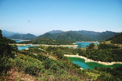 Scenic view of river and mountains against clear sky