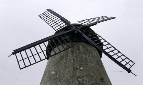 Low angle view of traditional windmill against sky