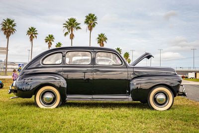 Vintage car on land against sky