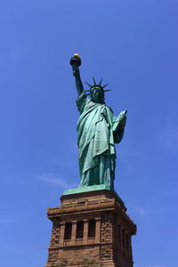 Low angle view of statue against blue sky