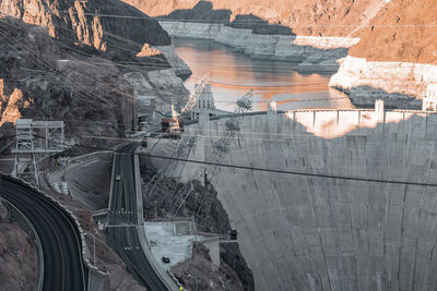 Aerial view of cables over arch bridge and hoover dam