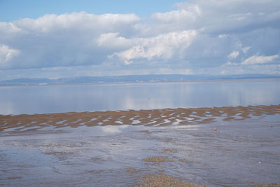 Panoramic photo of clevedon pier in somerset showing iron structure against blue sky