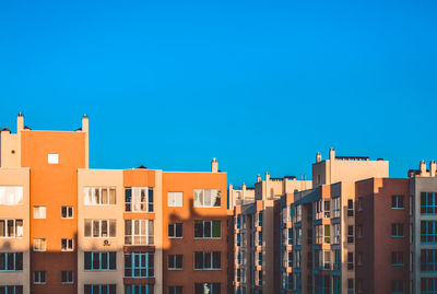 Low angle view of buildings against blue sky