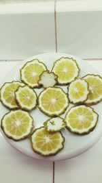 High angle view of fruits in plate on table