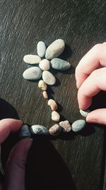 Close-up of hand holding pebbles