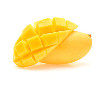 Close-up of yellow fruit against white background