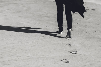 Low section of woman standing on beach