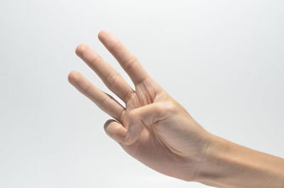 Close-up of person hand against white background