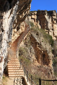 Low angle view of steps leading towards rocky mountains at sant feliu de codines