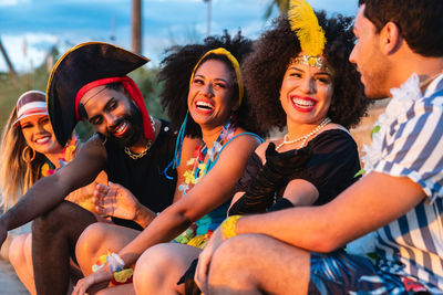 Cheerful friends sitting at home