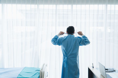 Rear view of man working in office