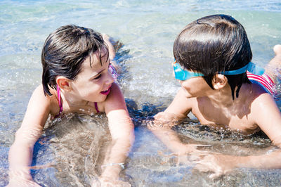 Kids lying on seashore