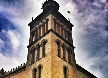 Low angle view of building against cloudy sky