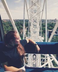 Young woman sitting on ferris wheel