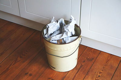 High angle view of garbage on hardwood floor