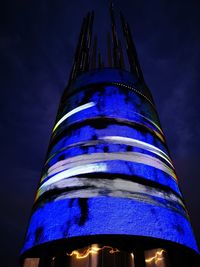 Low angle view of illuminated building against sky at night