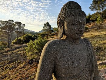 Statue of buddha against sky