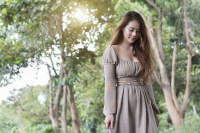 Young woman standing in forest