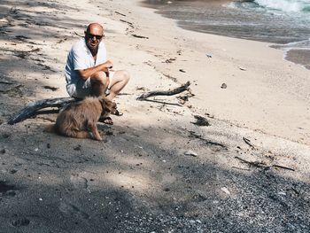 Full length of man with dog on beach