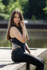 Portrait of beautiful woman sitting outdoors