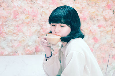 Young woman drinking coffee