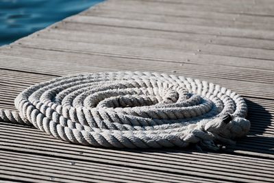 Rope on wooden pier during sunny day