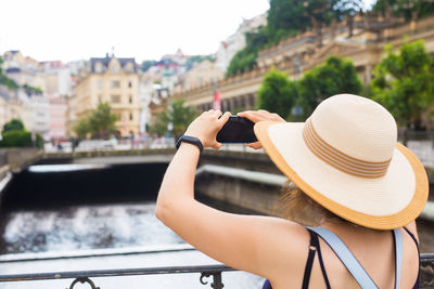 Rear view of woman using mobile phone