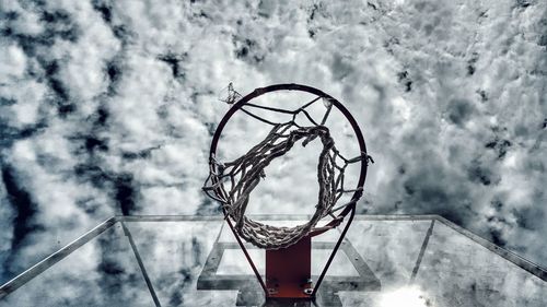 Close-up of basketball hoop against sky