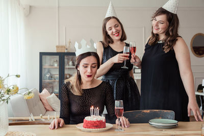 Happy young woman with hands on table