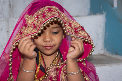 Girl kid cute facial expression in marriage ceremony dress from unique low angle shot in details