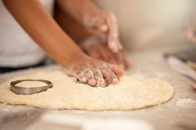 Midsection of woman with cookies on table