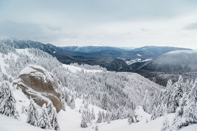 Scenic view of snow covered mountains against sky