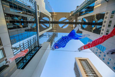 Low angle view of buildings against clear blue sky