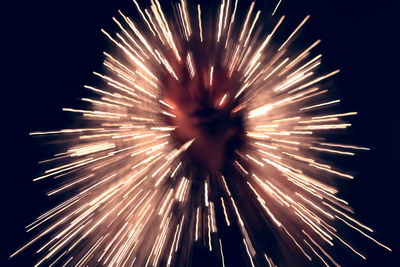 Low angle view of firework display at night