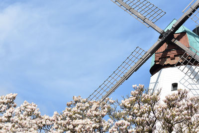 Low angle view of traditional windmill against sky