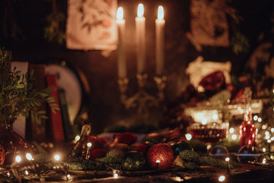 Christmas academia vintage table - fir, candles, wine, red decorations, books, glasses, gingerbread