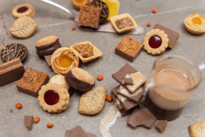 High angle view of cookies and hot chocolate in glass on table