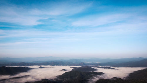 Scenic view of mountains against cloudy sky