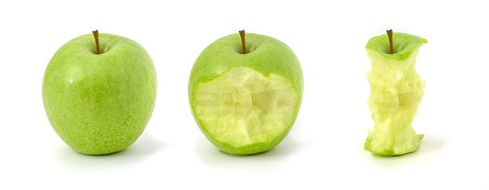 Close-up of green fruits against white background