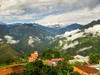 High angle view of houses and mountains against sky