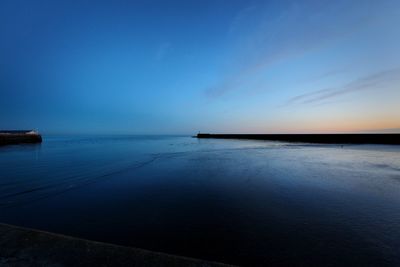 Scenic view of sea against sky at sunset