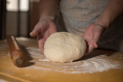 Close-up of person preparing food on table