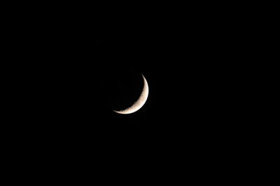 Low angle view of half moon against sky at night