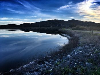 Scenic view of lake and mountains against sky